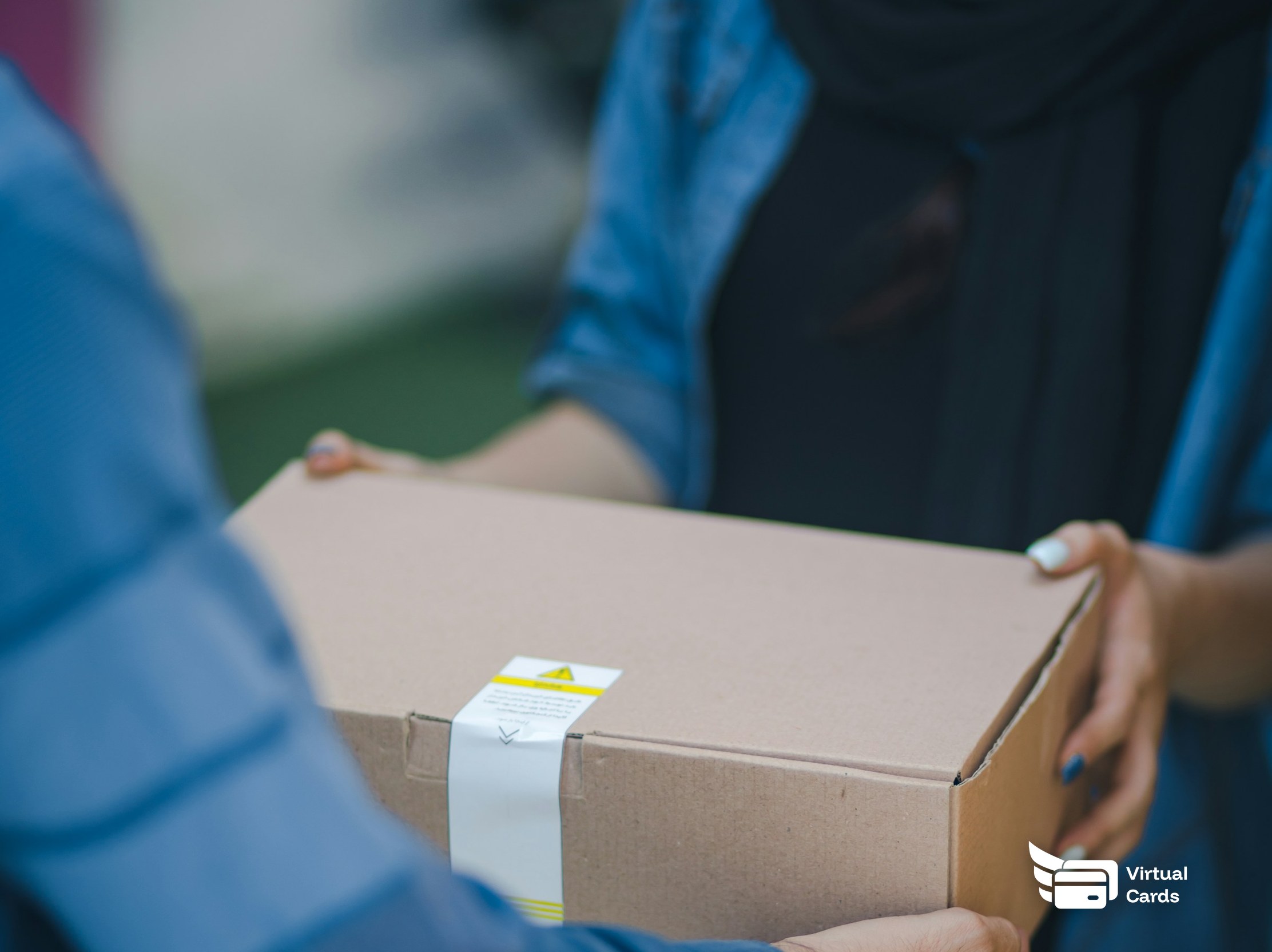 A small online seller packing parcels with shipping labels at a desk.