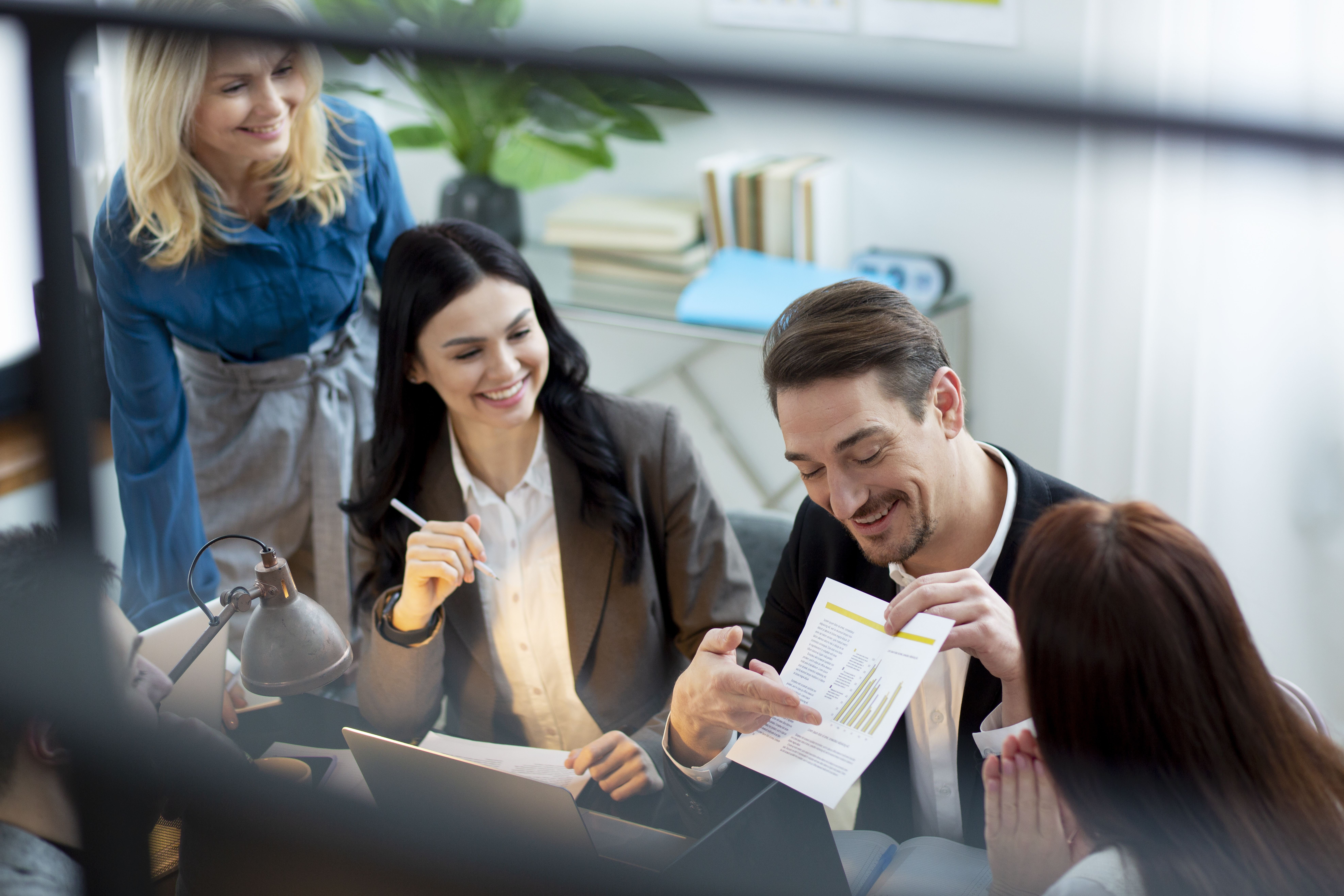 Team of employees reviewing spending card assignments together in an office