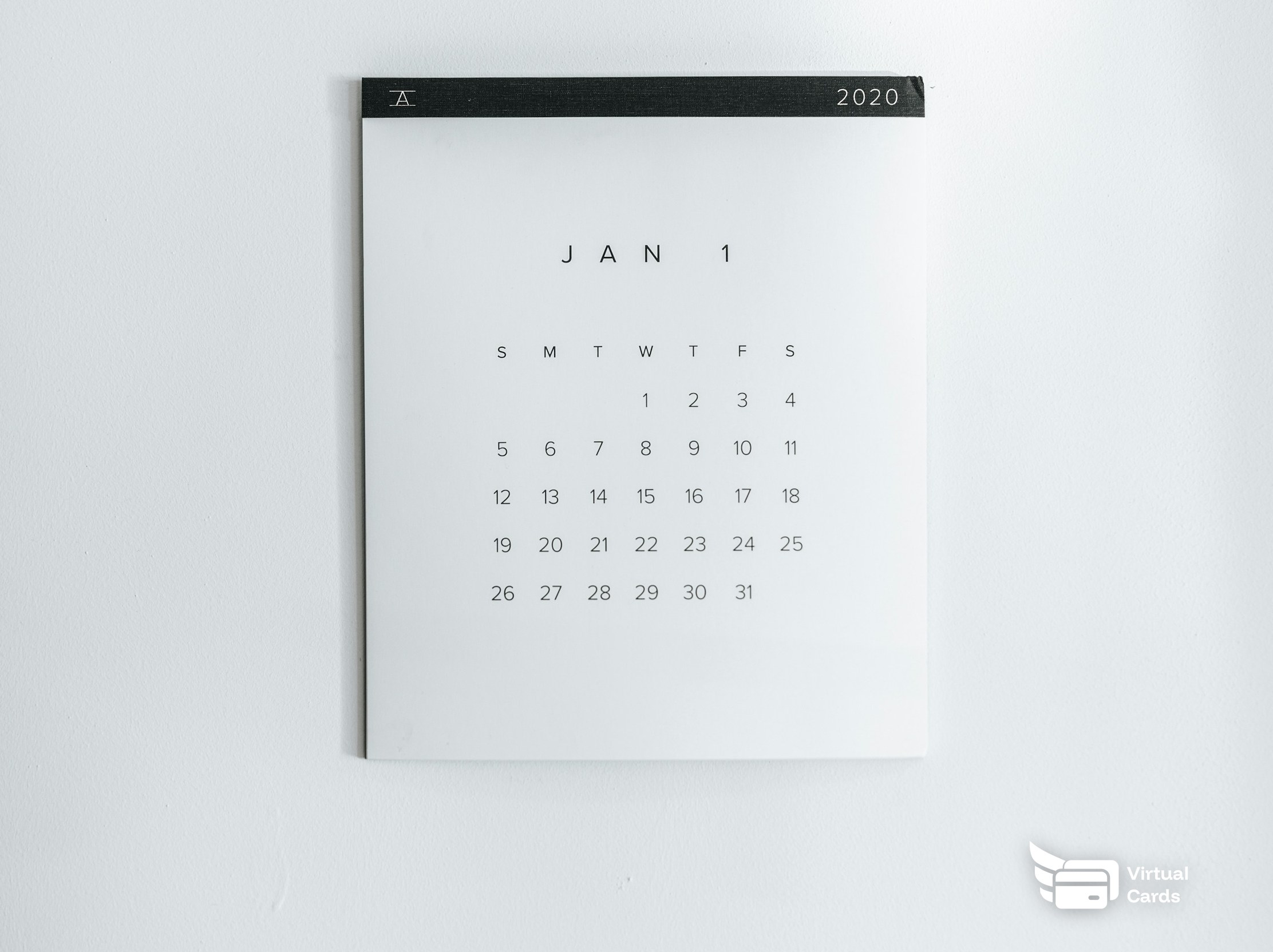 A wall calendar with a circled end date next to a smartphone, representing a free trial deadline tracked against a virtual Visa card.