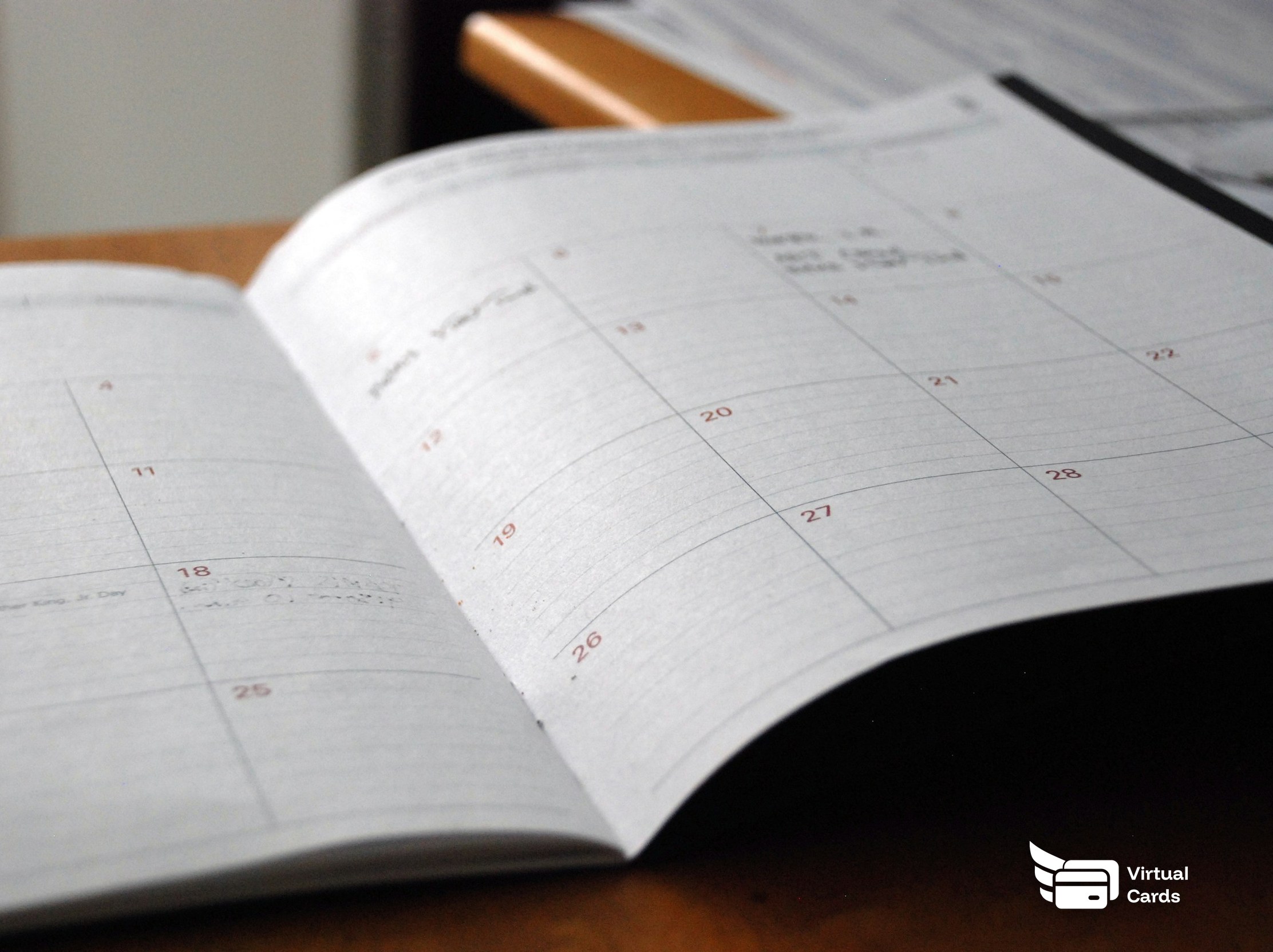 An open monthly planner on a desk, representing one-time and recurring schedules.