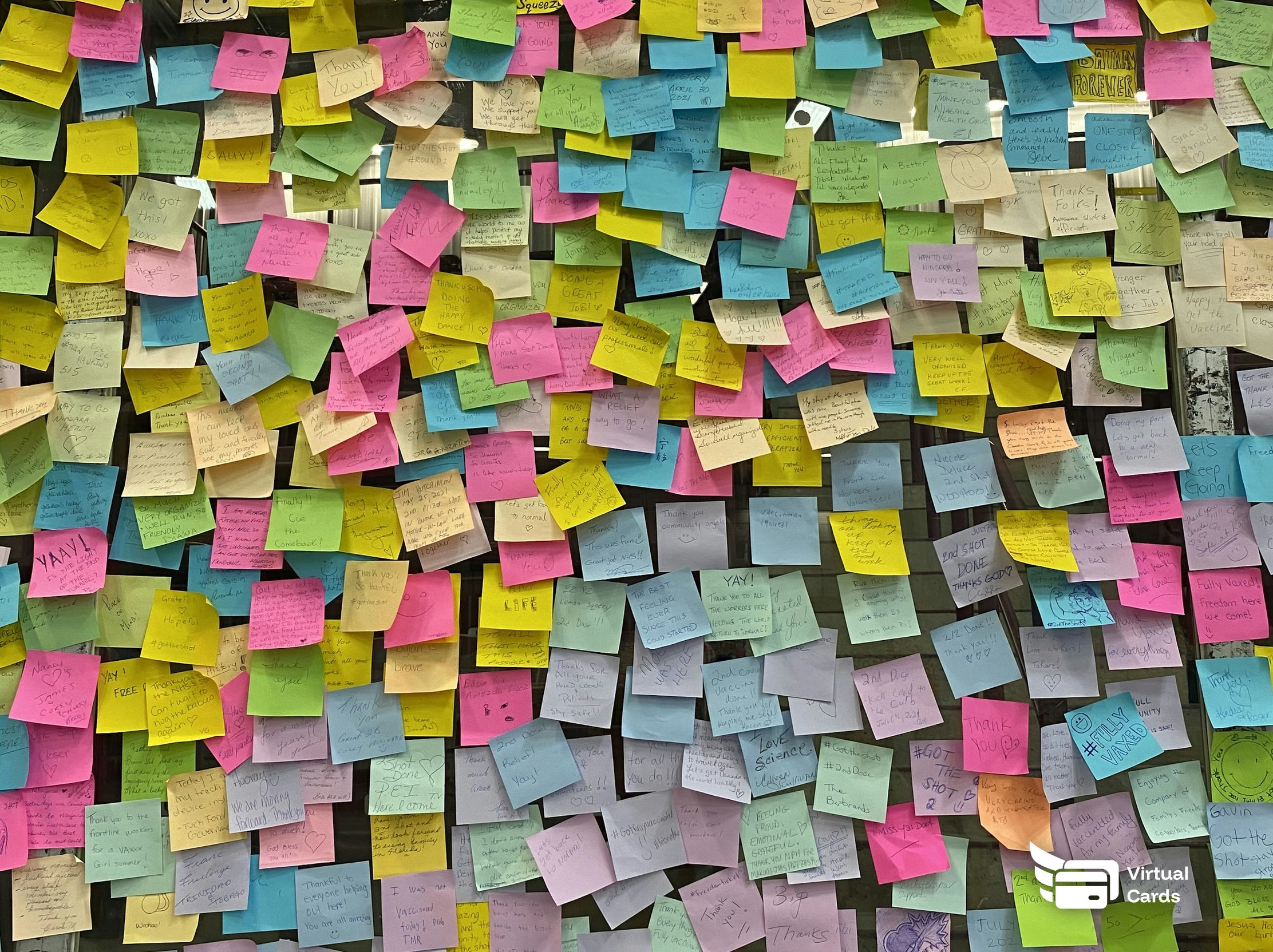 A wall covered in colorful sticky notes during a planning session.