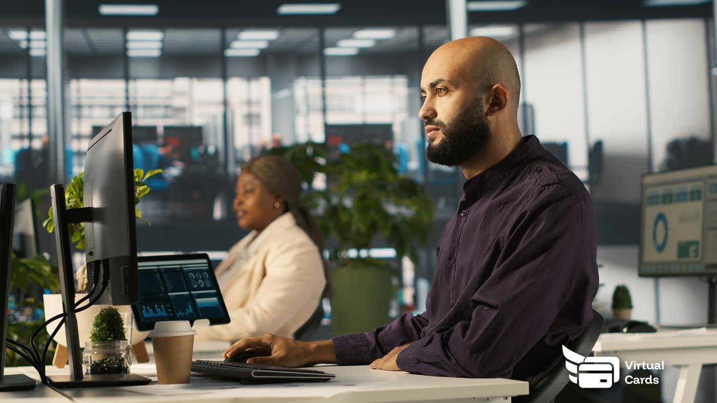 IT lead reviewing a virtual card dashboard showing per-tool SaaS subscription spend
