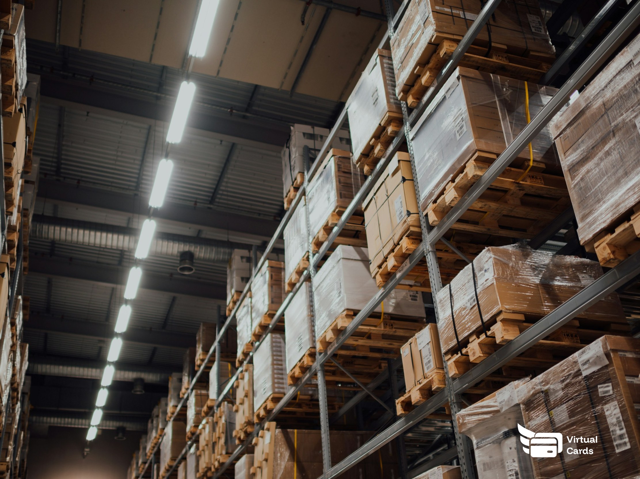 Stacked supplier boxes on warehouse shelving, representing recurring vendor payments managed on capped virtual Visa cards.