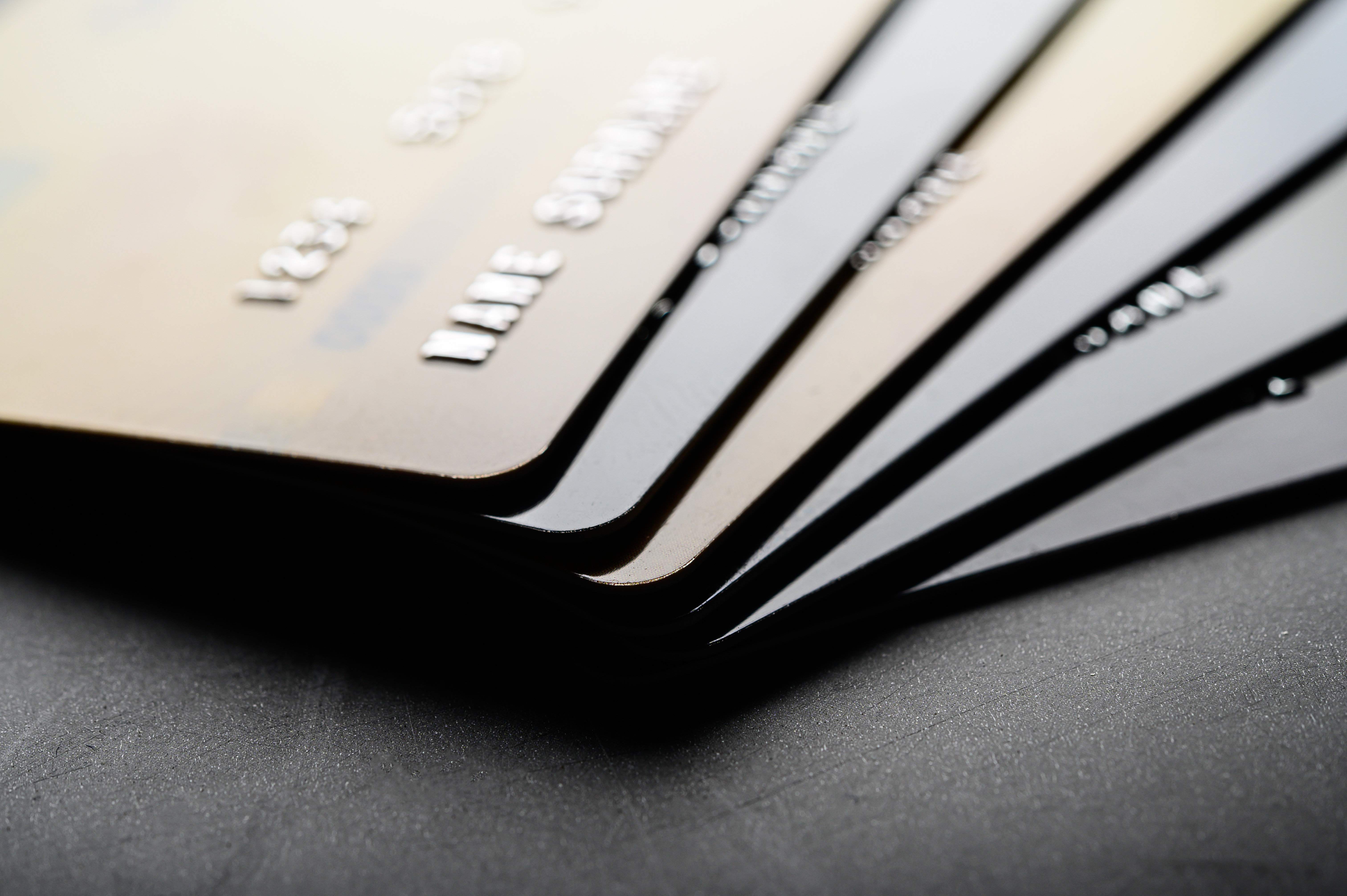 Multiple business cards fanned out on a dark surface for comparison