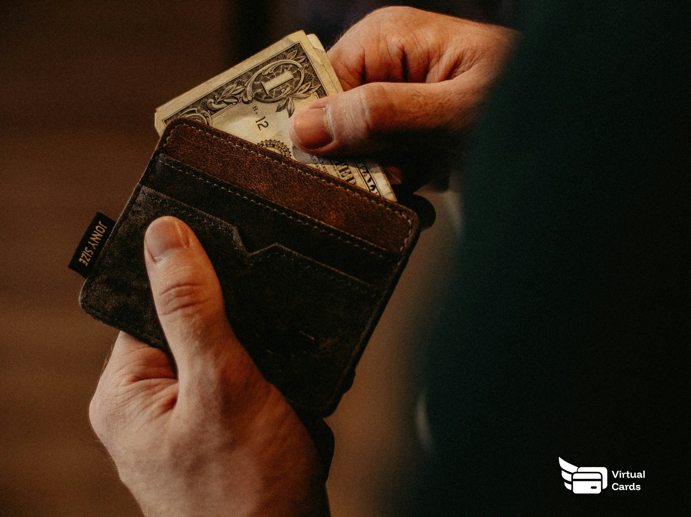 A hand taking cash from a leather wallet, representing spending your own money.
