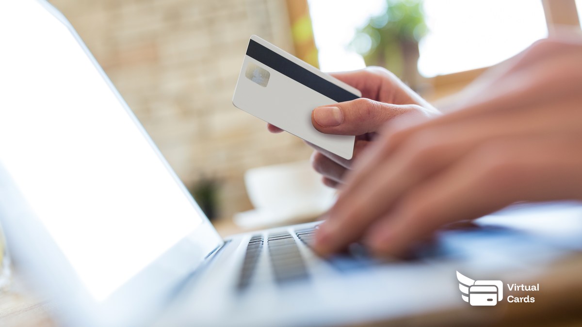 A close-up of a phone screen showing a masked Visa virtual card number being revealed for an online checkout, with the gold Virtual Card Maker card resting beside it.