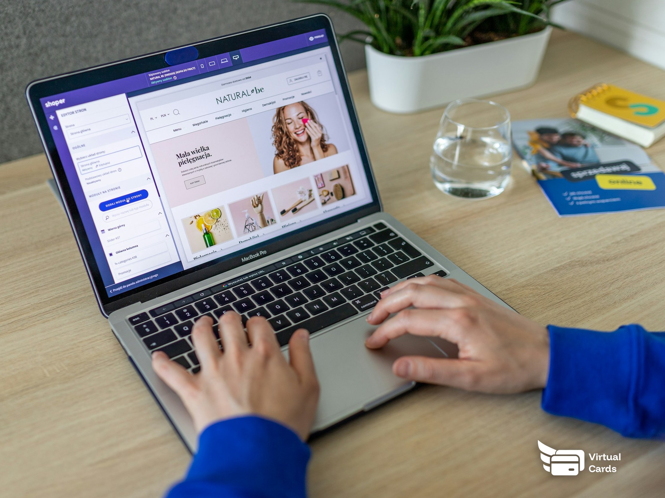 A person shopping online on a laptop at a desk.